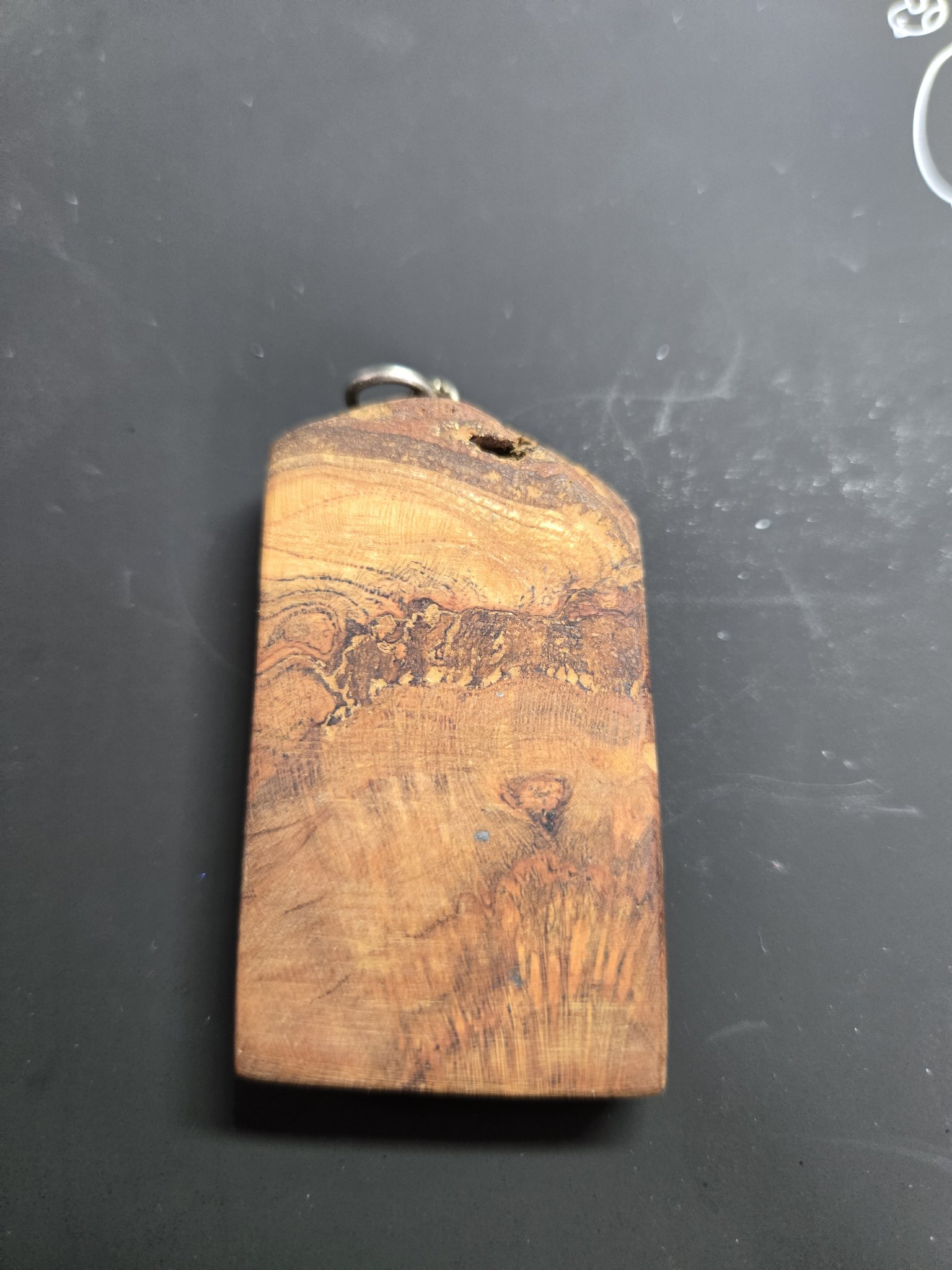 Back of the spalted maple pendant showing its natural grain and hand-finished surface