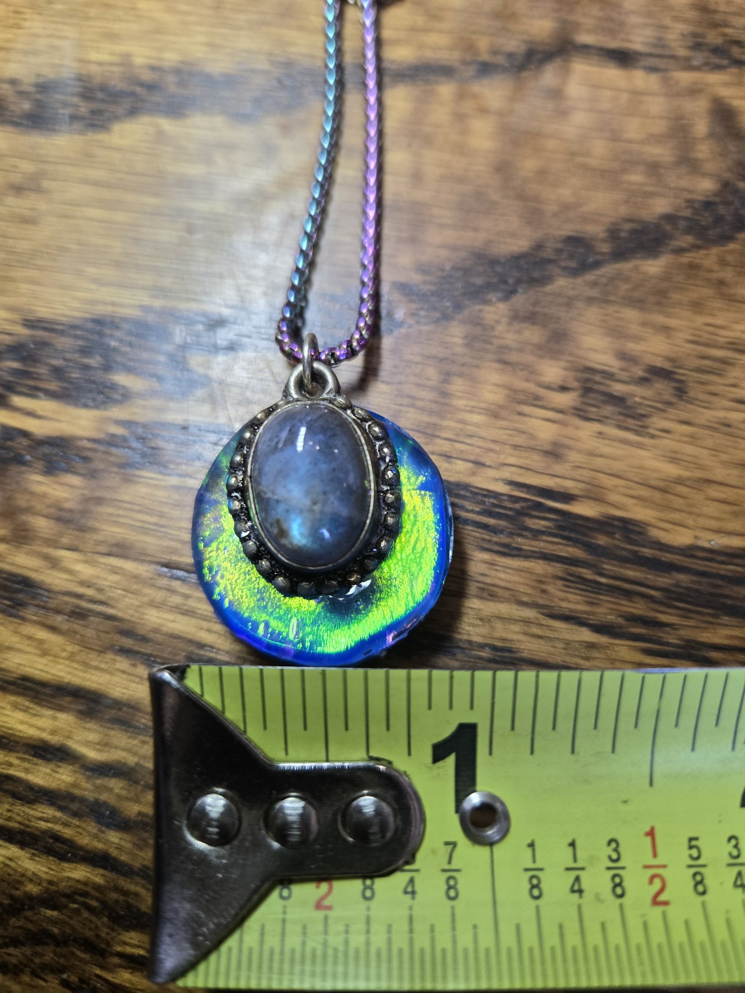 Labradorite holographic pendant shown beside a tape measure