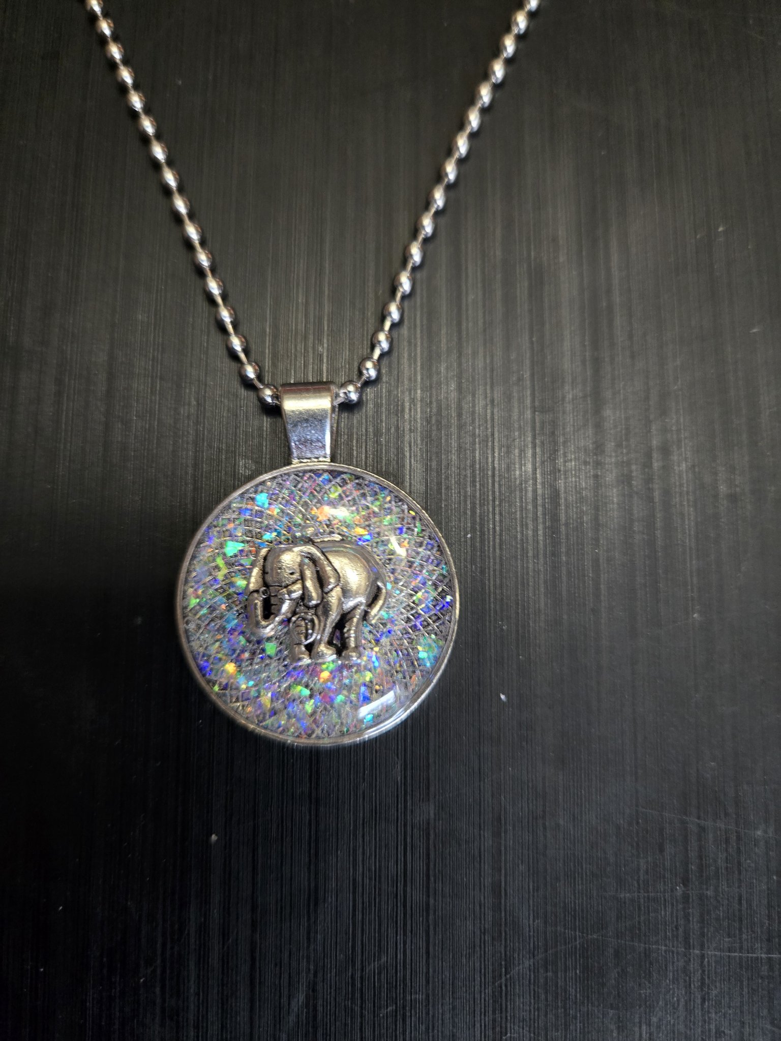 Close-up front view of the holographic glitter elephant pendant