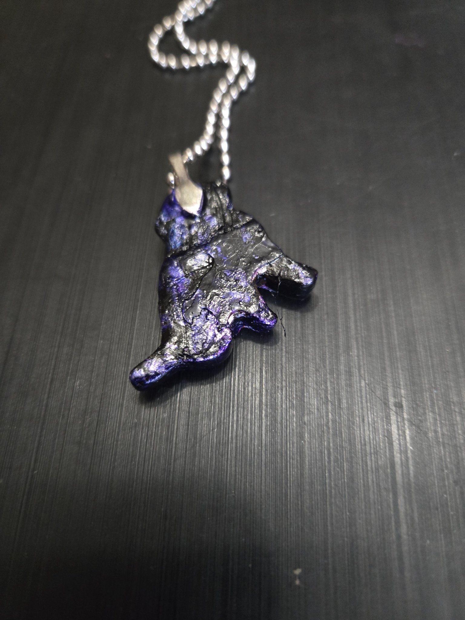 Back view of the dog-shaped polymer clay pendant