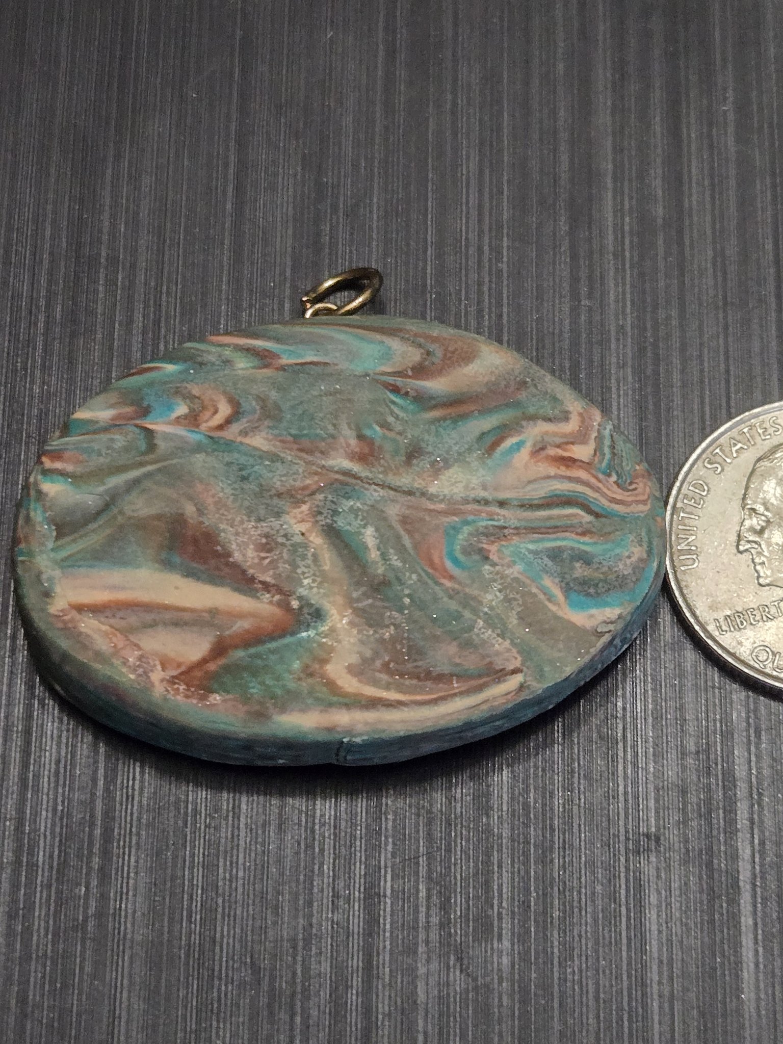 Marbled teal and brown back of stock 153 beside a quarter for scale