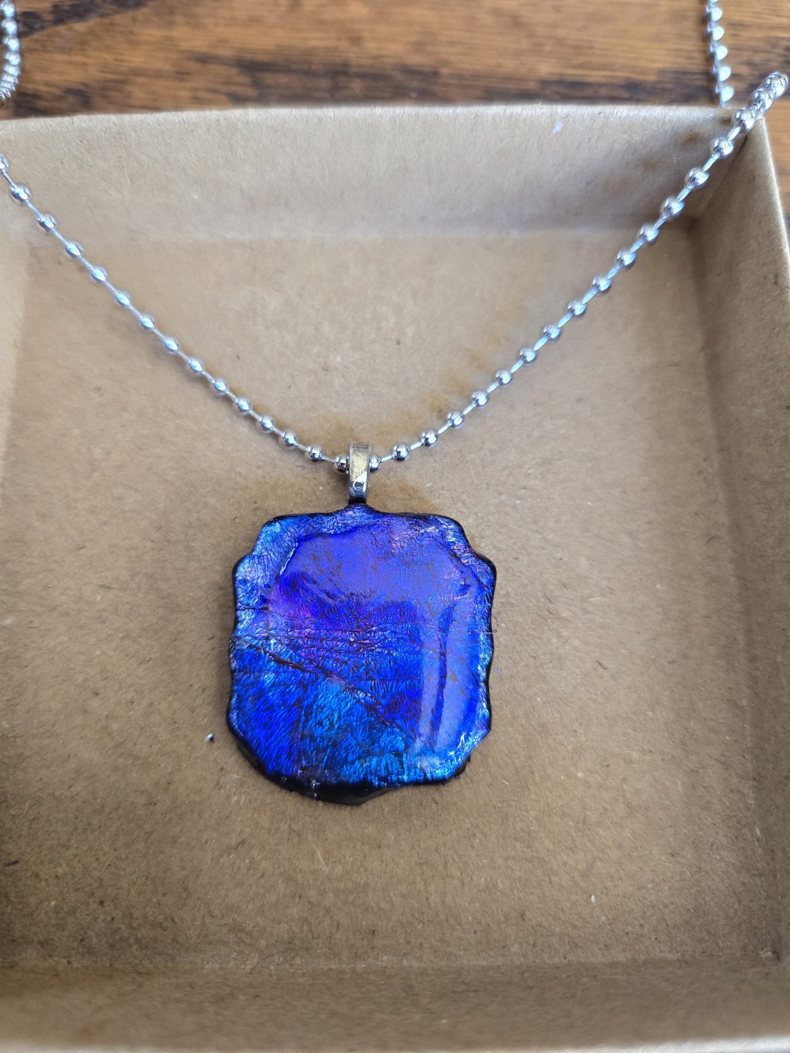 Stock 174 freeform polymer clay pendant with silver leaf and vivid blue-purple alcohol inks under glossy resin, shown in a front close-up