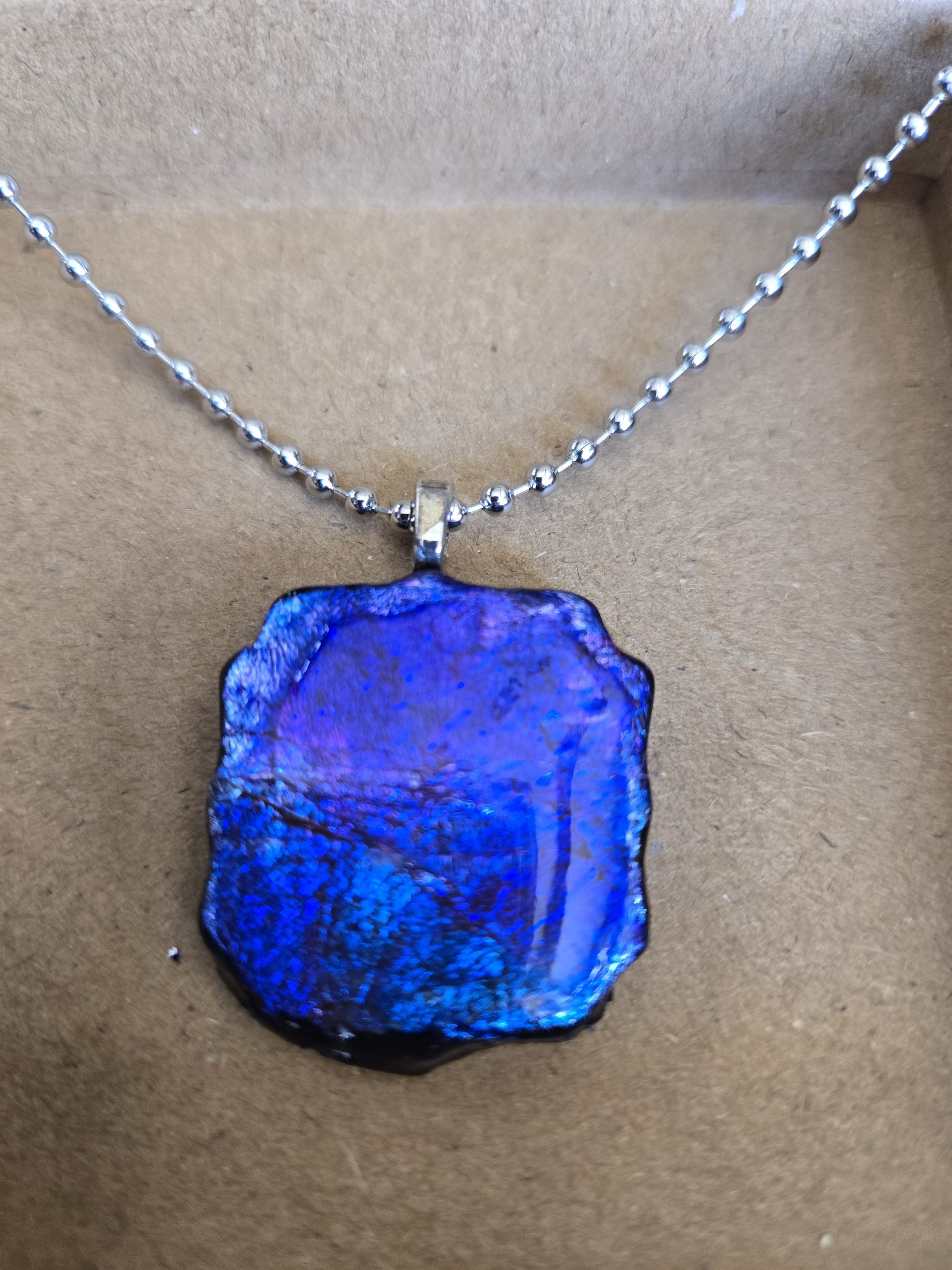 Alternate angle of stock 174 showing its blue and purple alcohol ink color shift, silver leaf, and resin finish