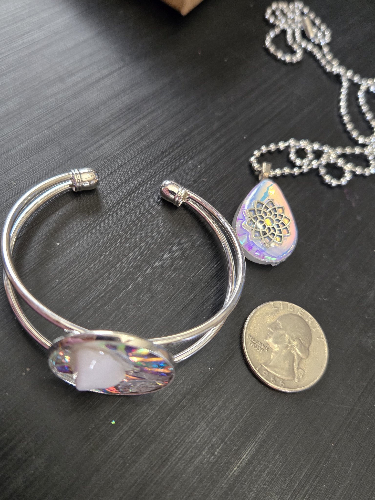 Stock 184 adjustable holographic quartz cuff bracelet beside a quarter for scale