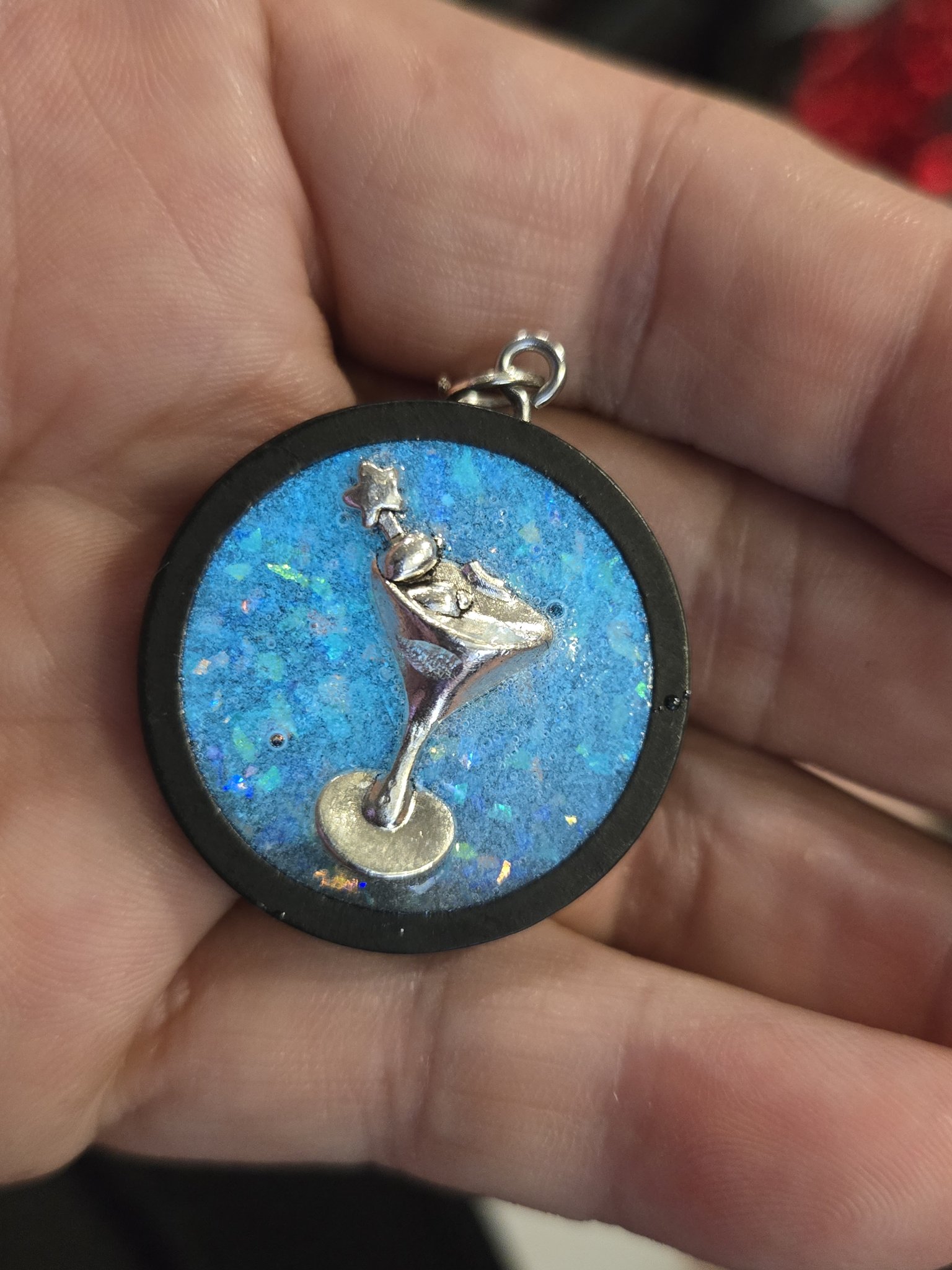Alternate front view of stock 203 blue resin pendant with holographic flakes and a silver-tone martini glass charm