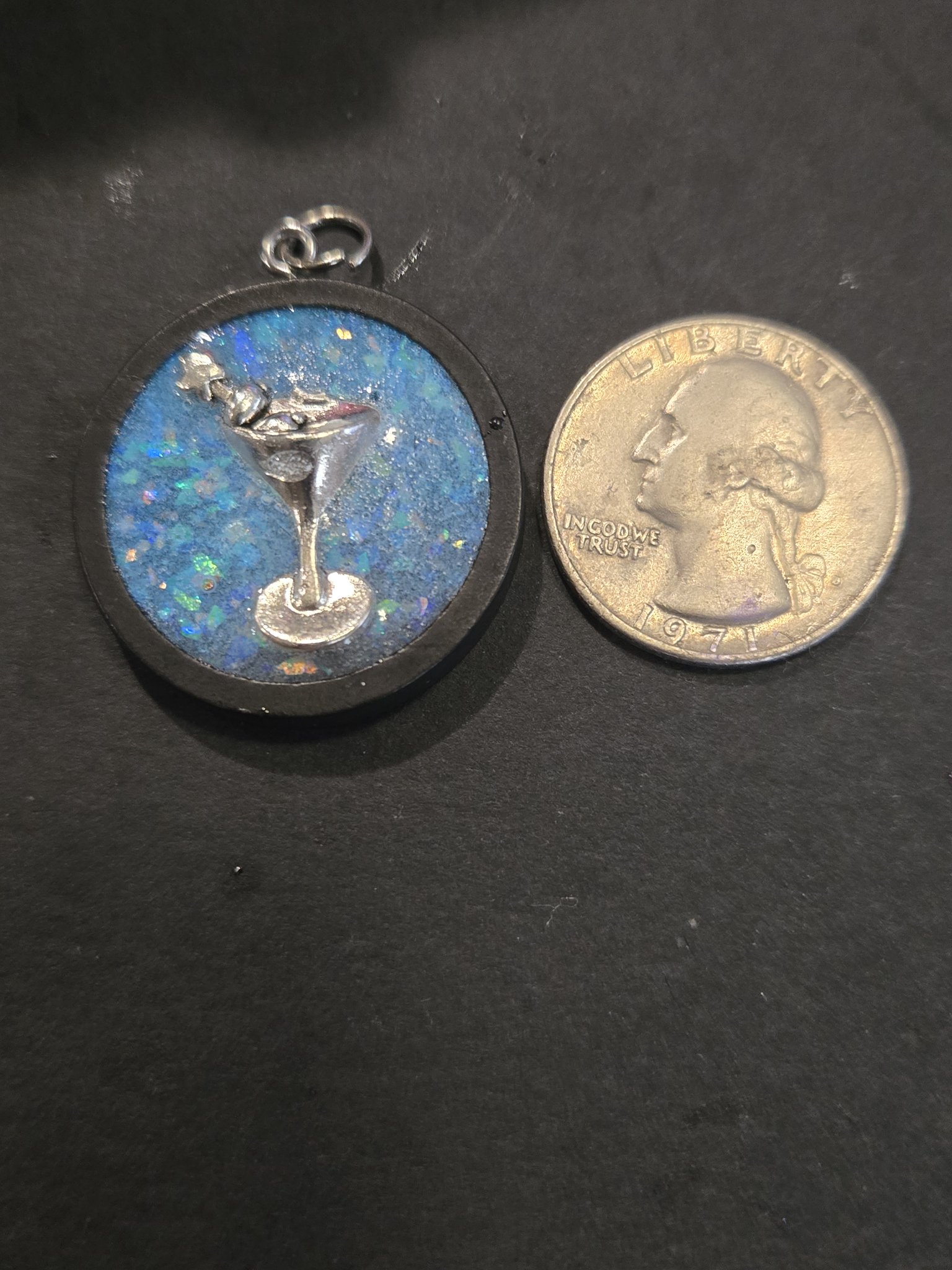 Front of stock 203 martini resin pendant beside a quarter for scale