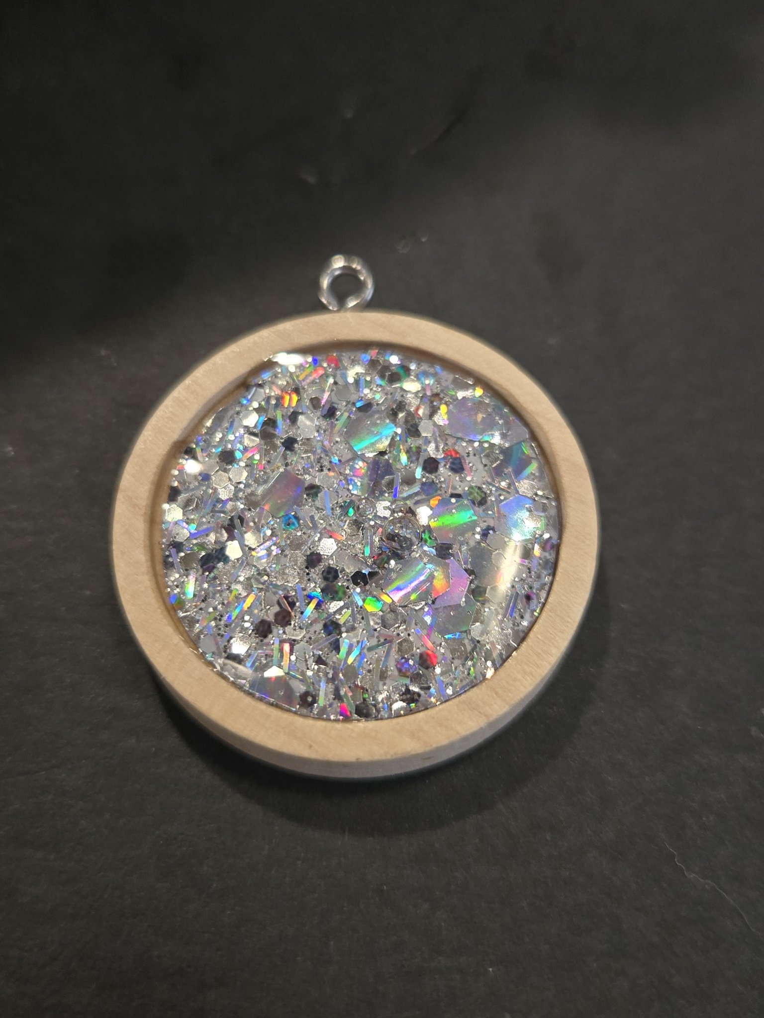 Alternate front angle of stock 205 holographic iridescent resin pendant in a wood frame