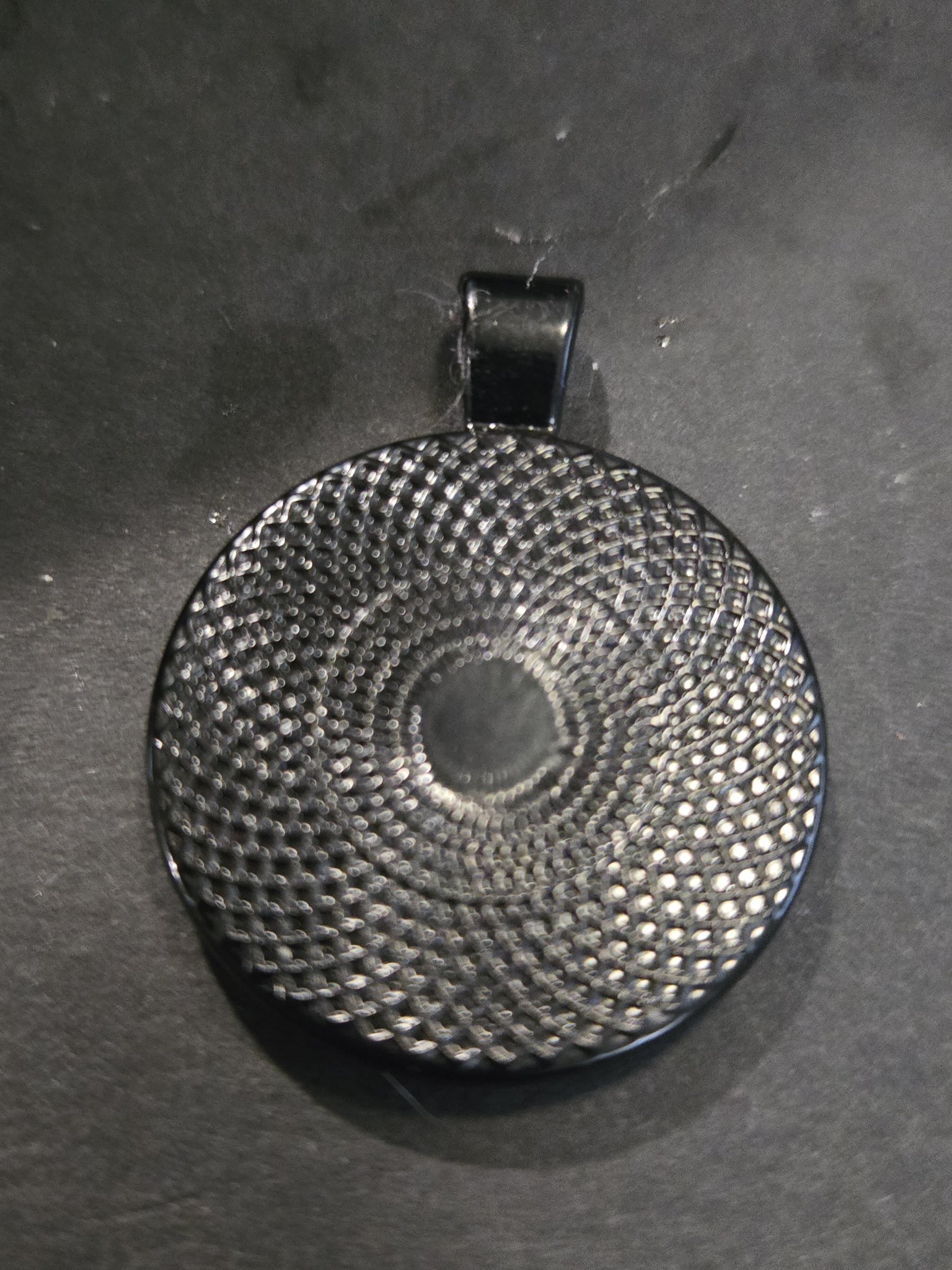 Back of stock 206 holographic dragonfly resin pendant in its black metal frame