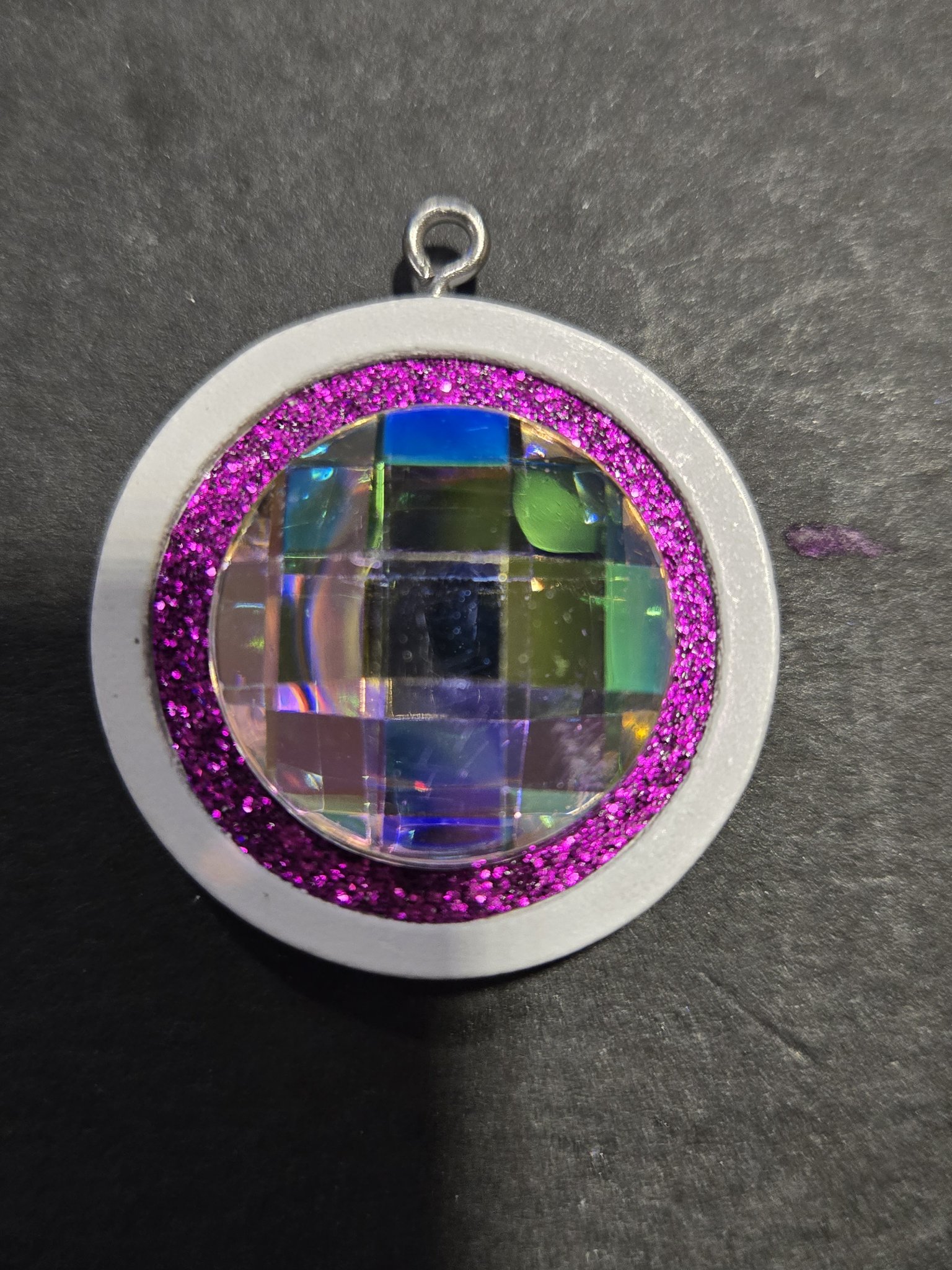 Stock 208 round disco ball pendant with pink sparkle in a white wood frame, shown from the front