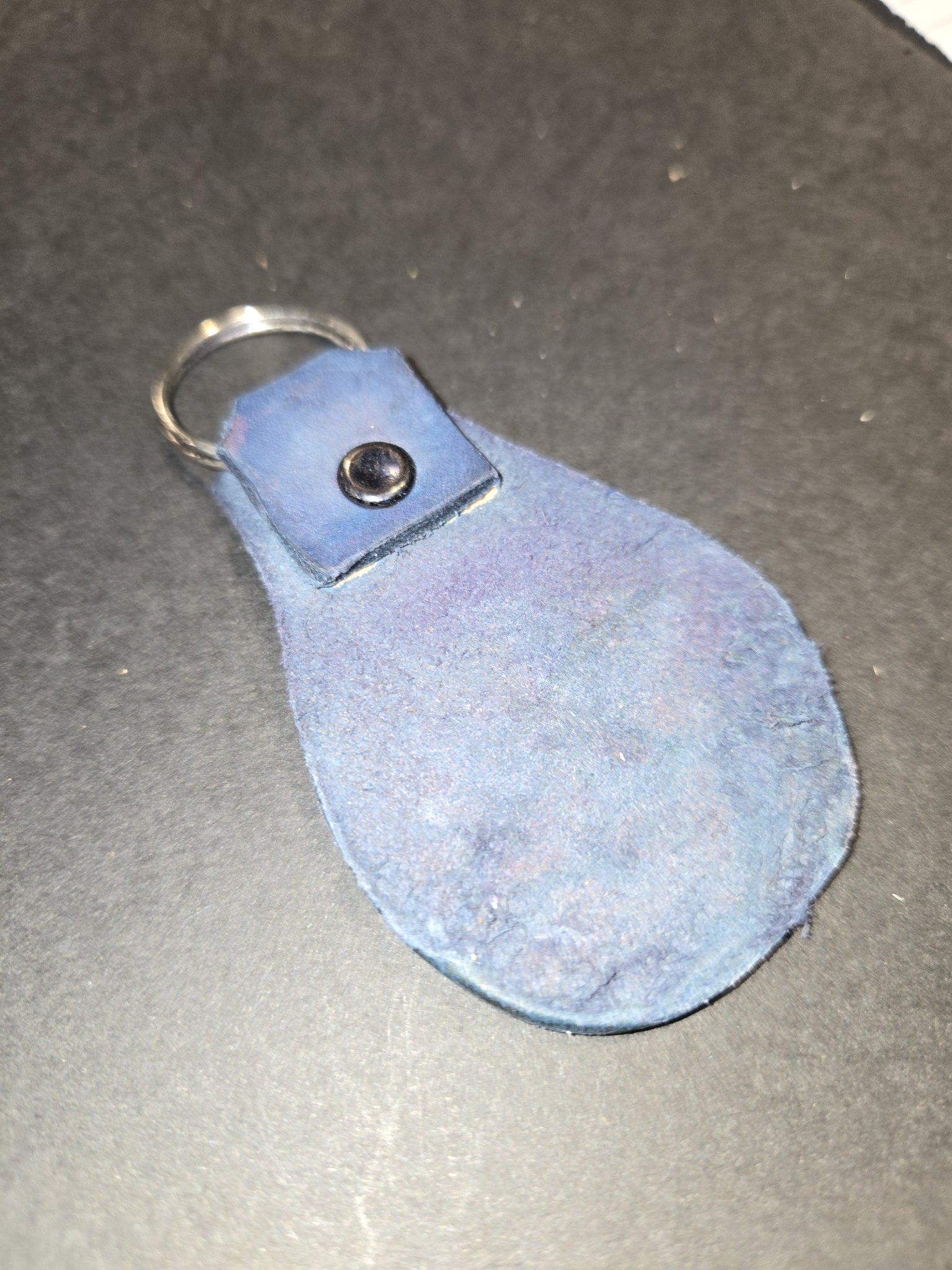 Back of stock 234 showing the blue suede side of the leather and the riveted loop holding the split key ring