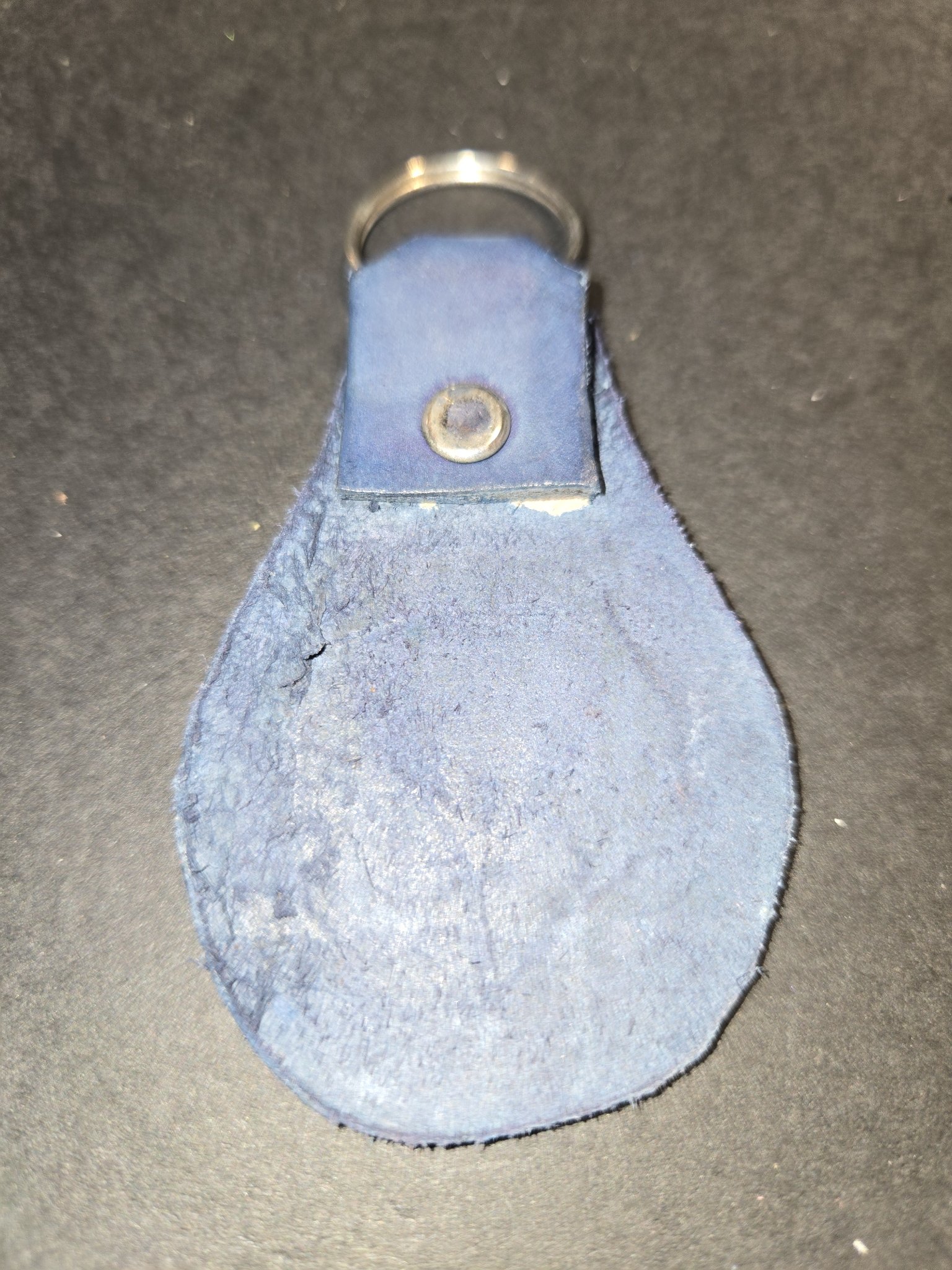 Back of stock 235 showing the blue suede side of the leather and the riveted loop holding the split key ring