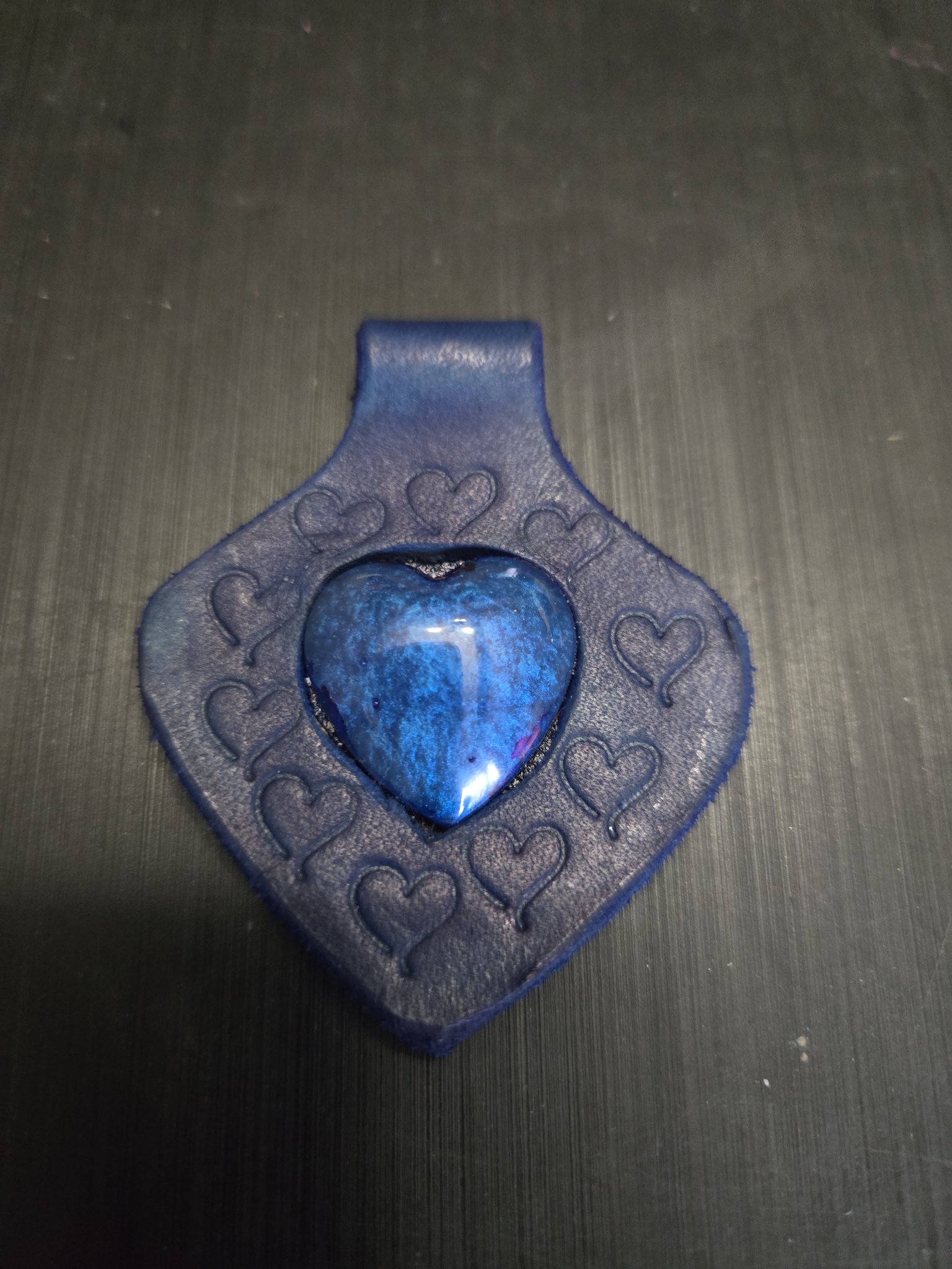 Stock 149 blue hand-stamped leather heart pendant with a blue heart stone