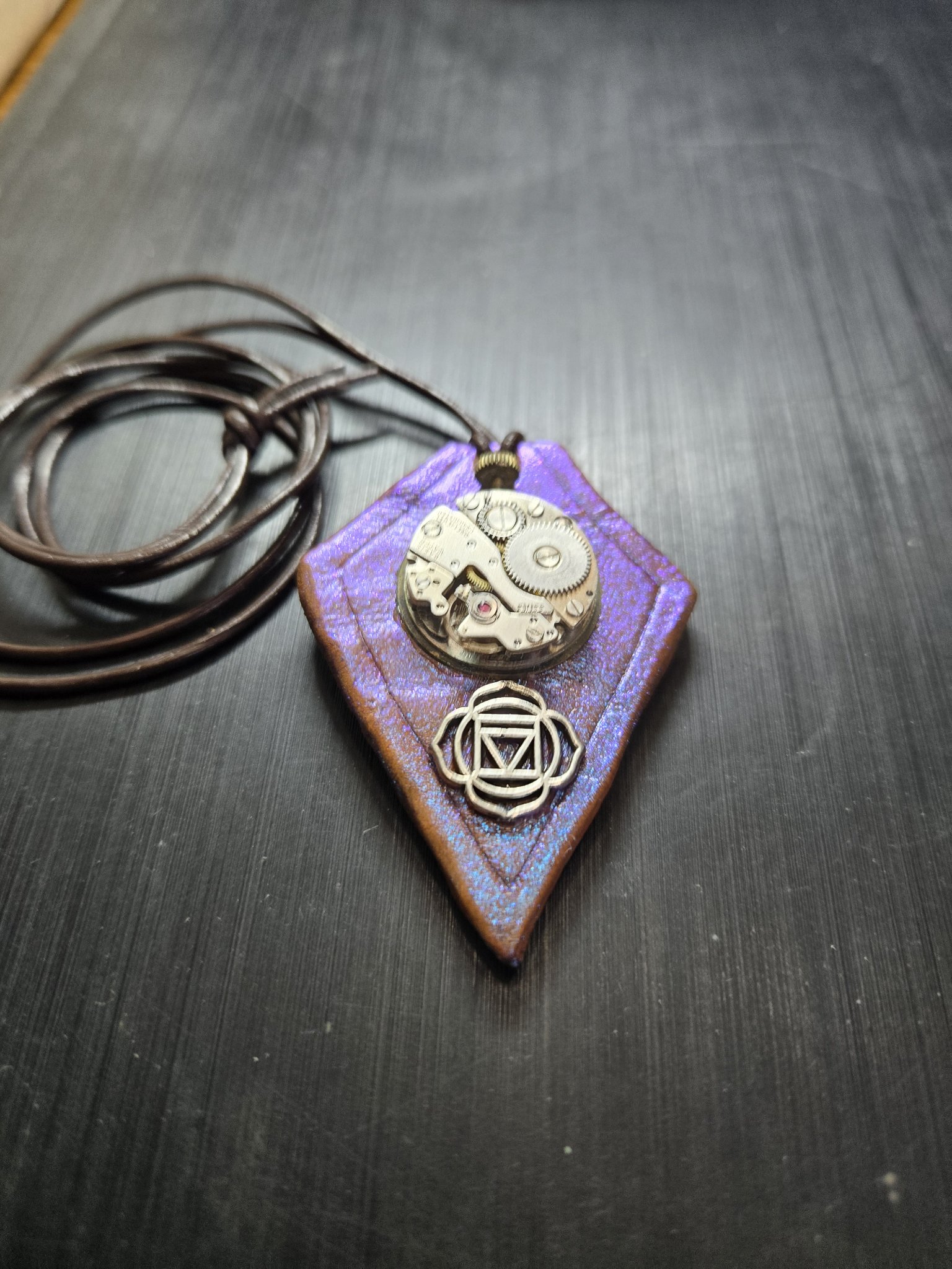 Stock 158 diamond-shaped purple color-change leather pendant with a genuine Swiss watch movement, silver-tone chakra charm, and brown leather necklace