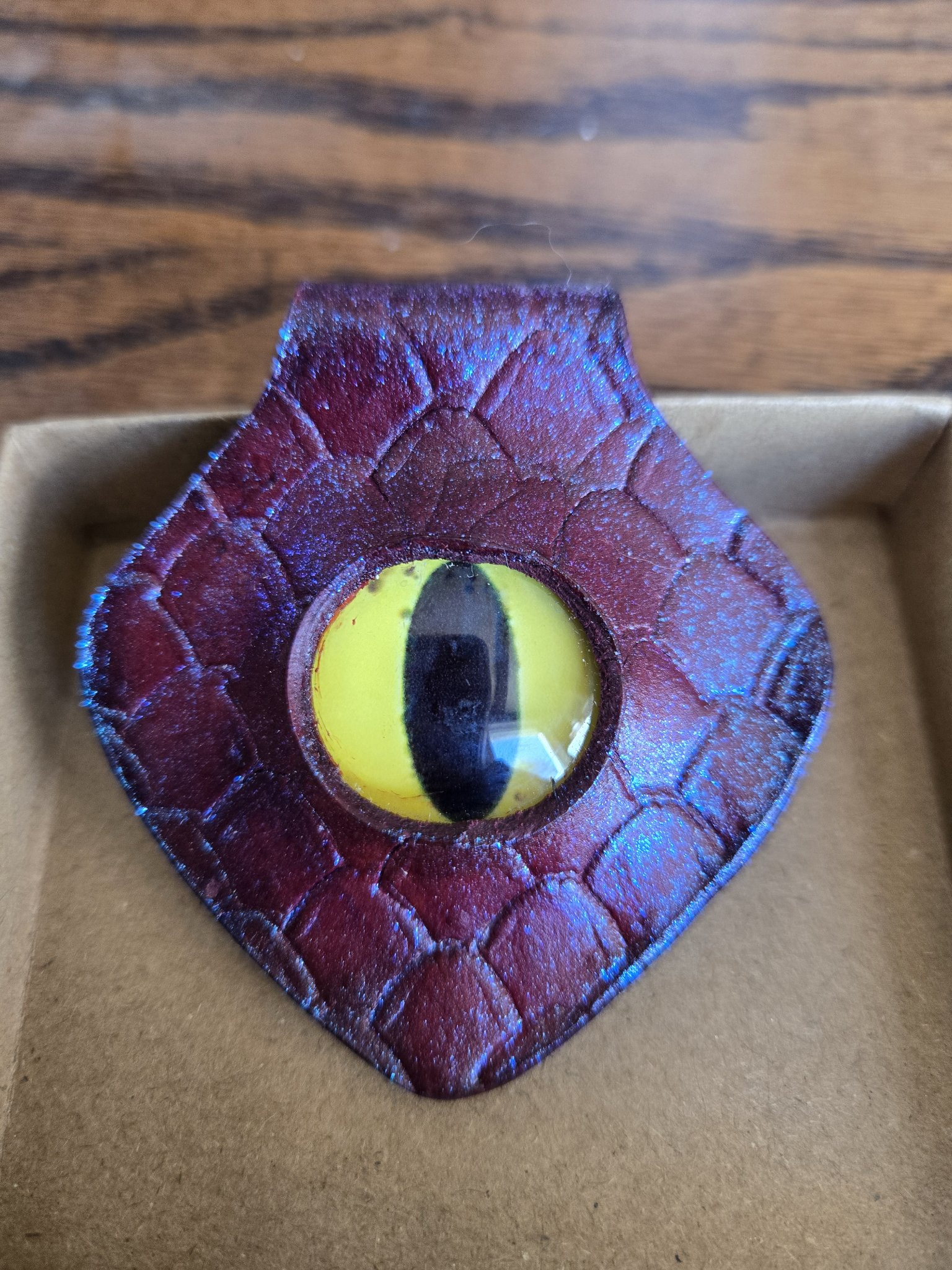 Alternate close-up angle of stock 172 showing the blue-purple color-change shimmer and yellow dragon eye cabochon