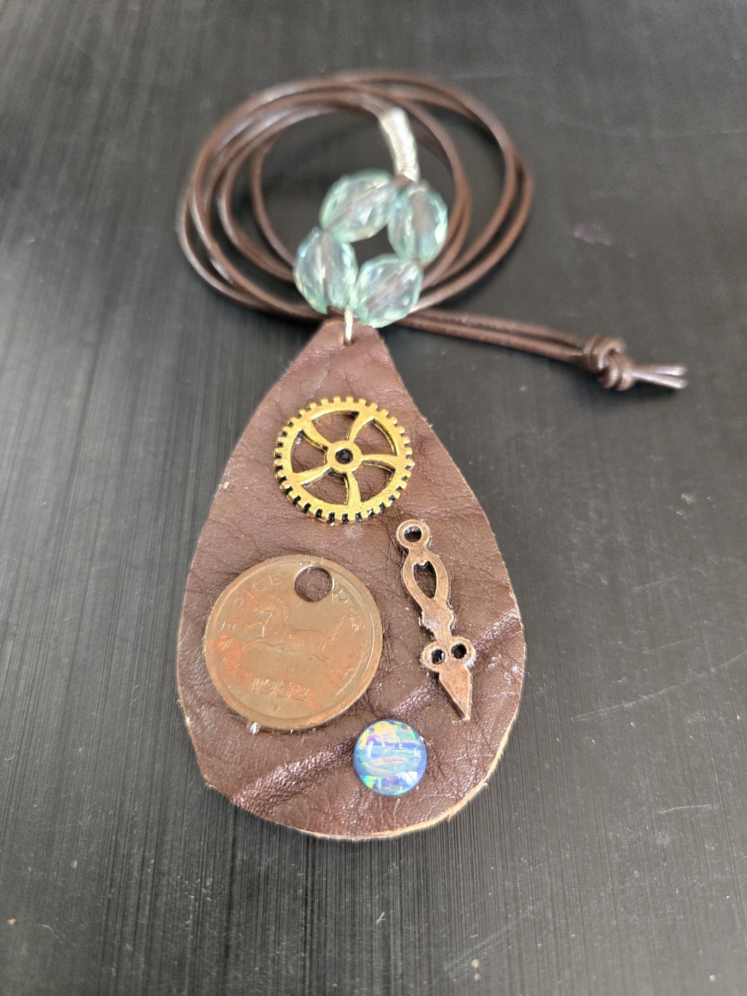 Full front view of stock 180 steampunk buffalo leather pendant with its 36-inch brown leather cord necklace