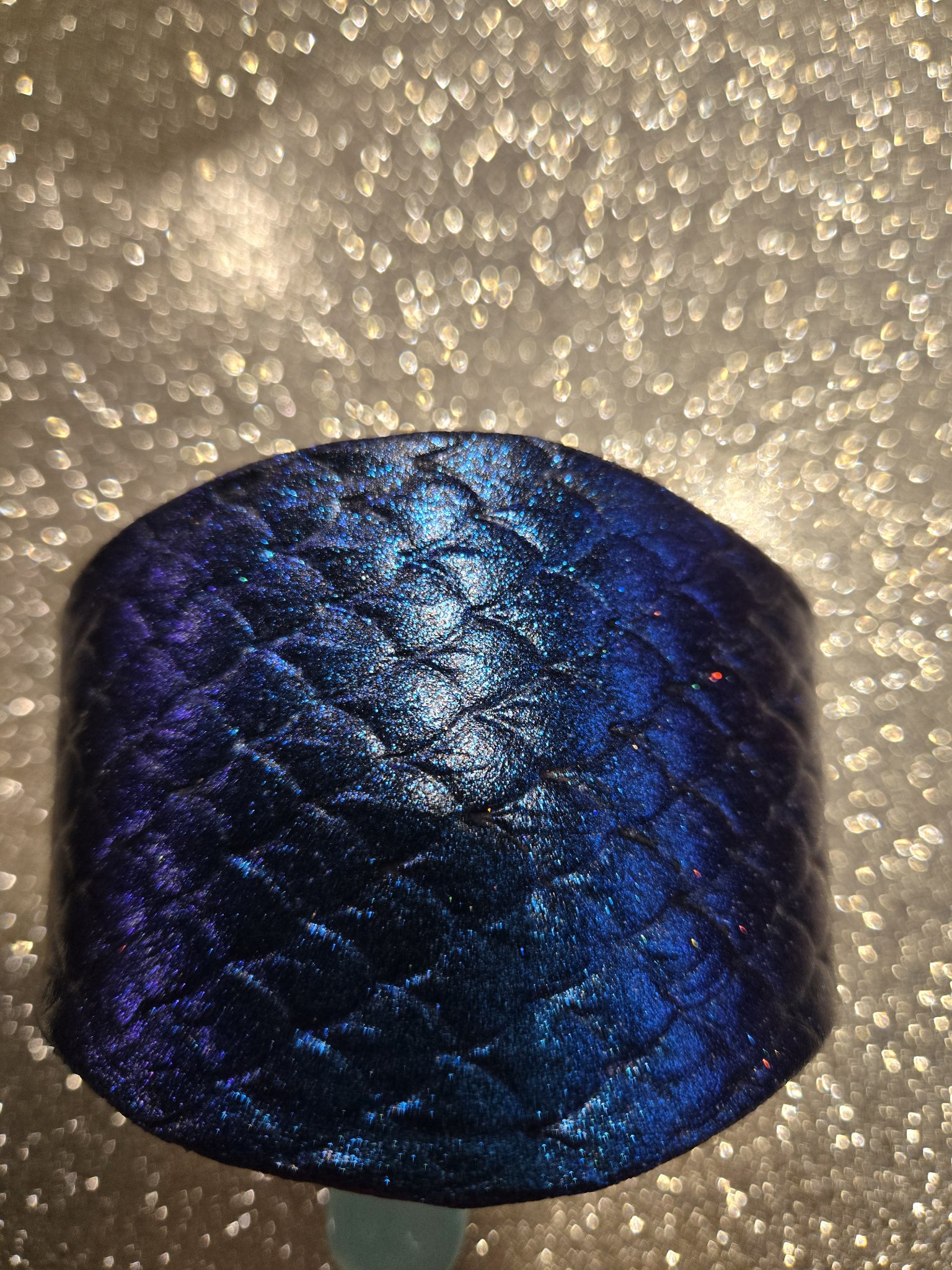 Close-up showing the blue and purple color shift on stock 213 leather cuff