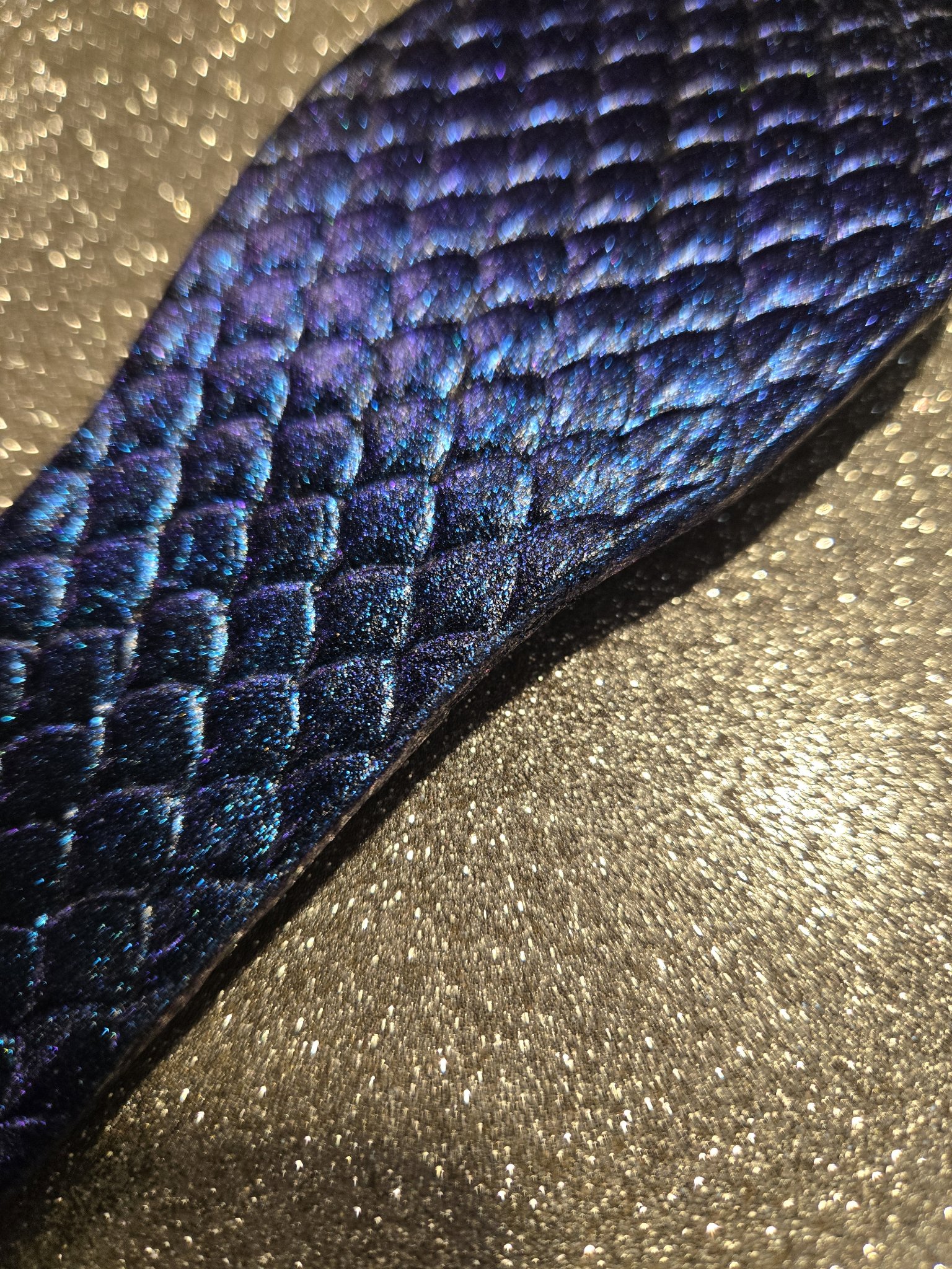 Detail of the blue and purple dragon scale pattern on stock 213 leather cuff
