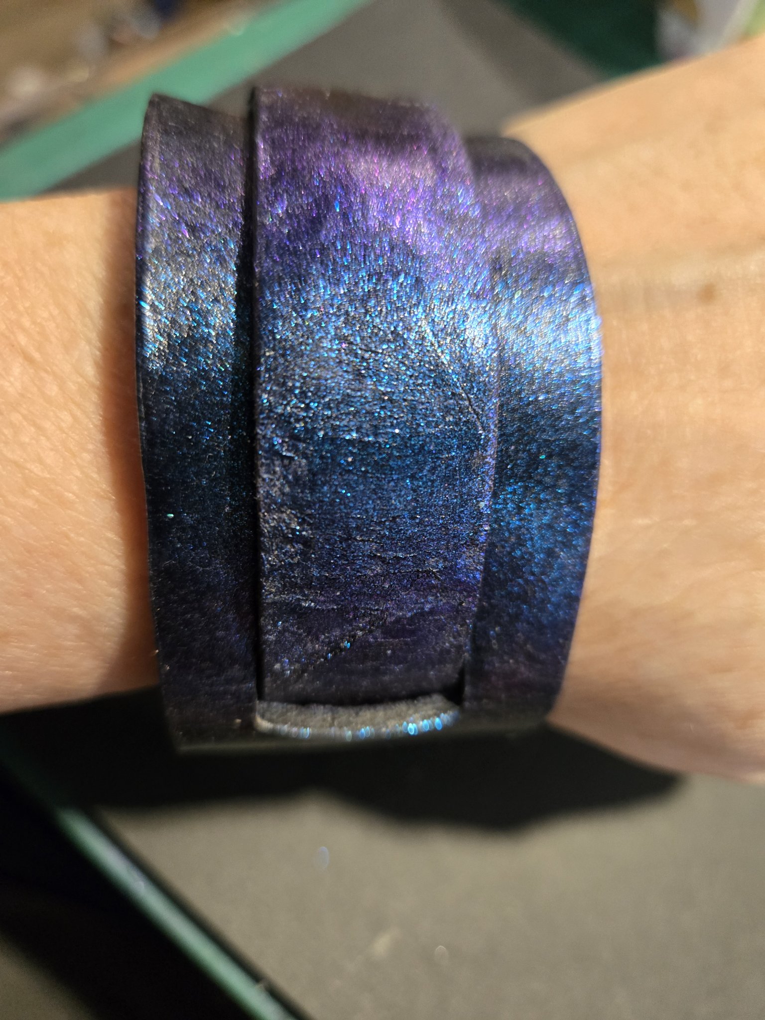 Stock 216 color change blue and purple leather cuff shown on a wrist