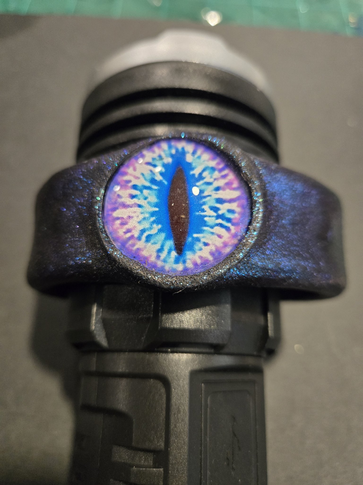 Front view of stock 219 showing the vivid blue dragon eye and sparkling blue leather