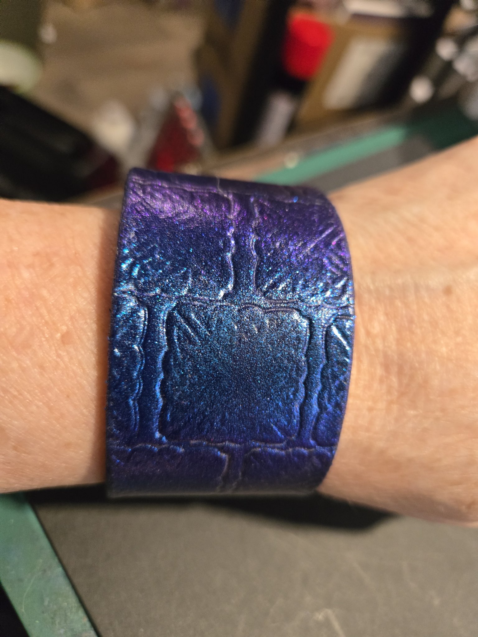 Stock 220 blue and purple color-change leather cuff shown on a wrist