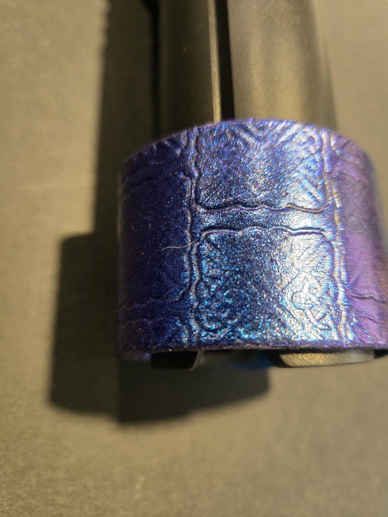 Angled view of stock 220 showing the color-changing blue and purple leather