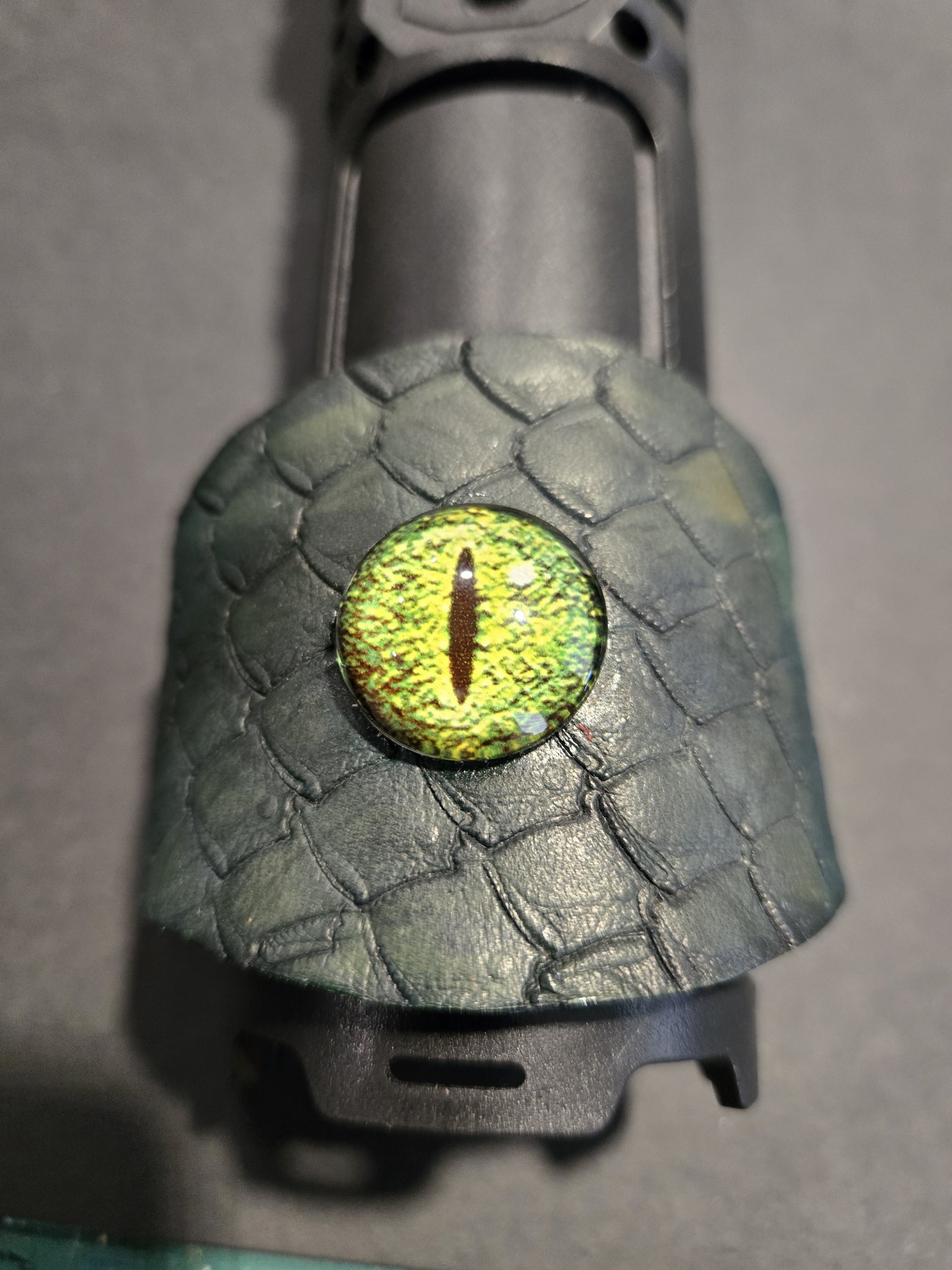 Stock 221 standing on display showing the green dragon scale texture and vivid green dragon eye
