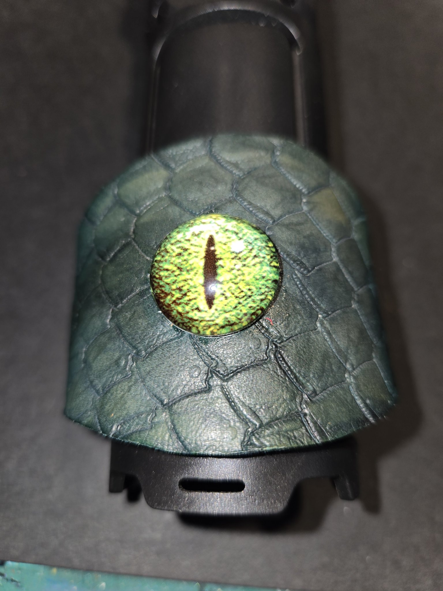 Front view of stock 221 showing the vivid green dragon eye at the wide center of the cuff