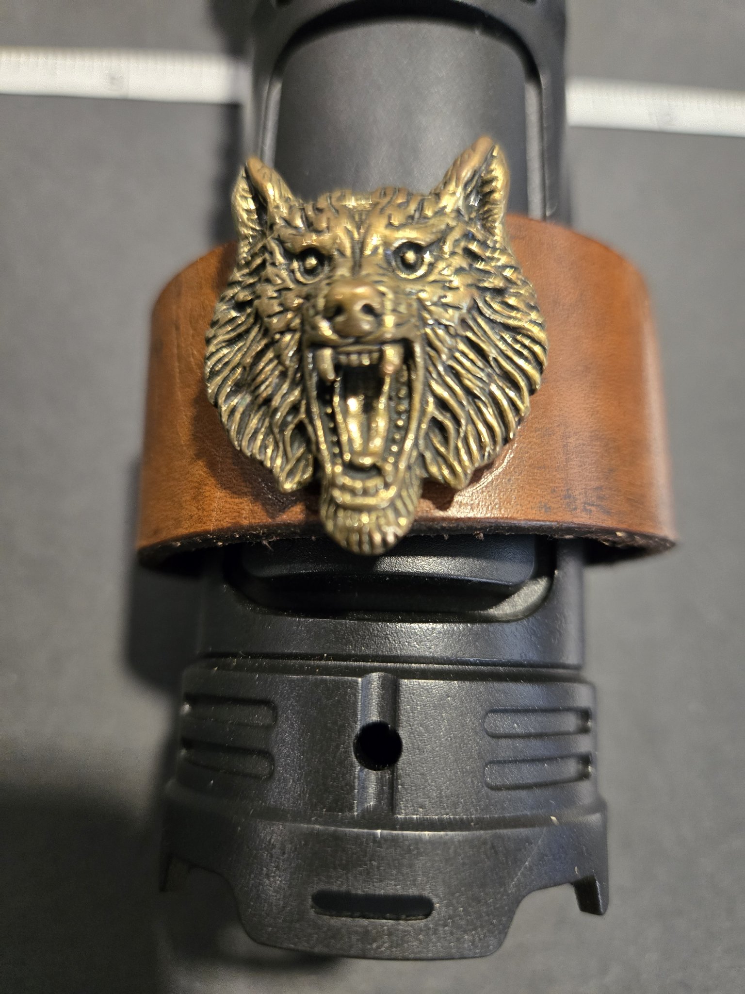 Front view of stock 222 showing the detailed bronze wolf head