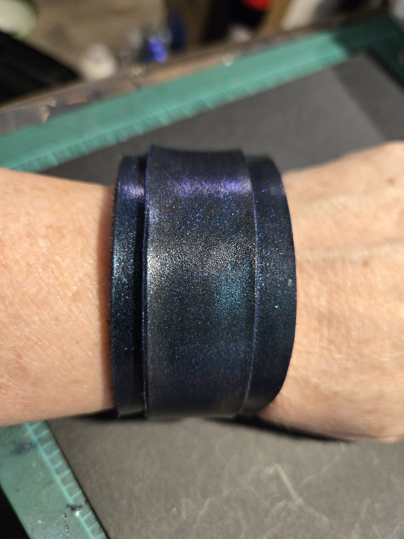 Stock 224 blue and purple color-shift leather cuff shown on a wrist