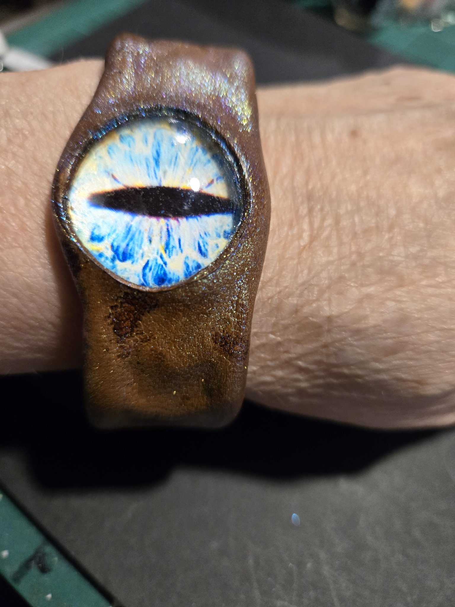 Stock 226 dragon eye leather cuff with a vivid blue dragon eye, shown on a wrist