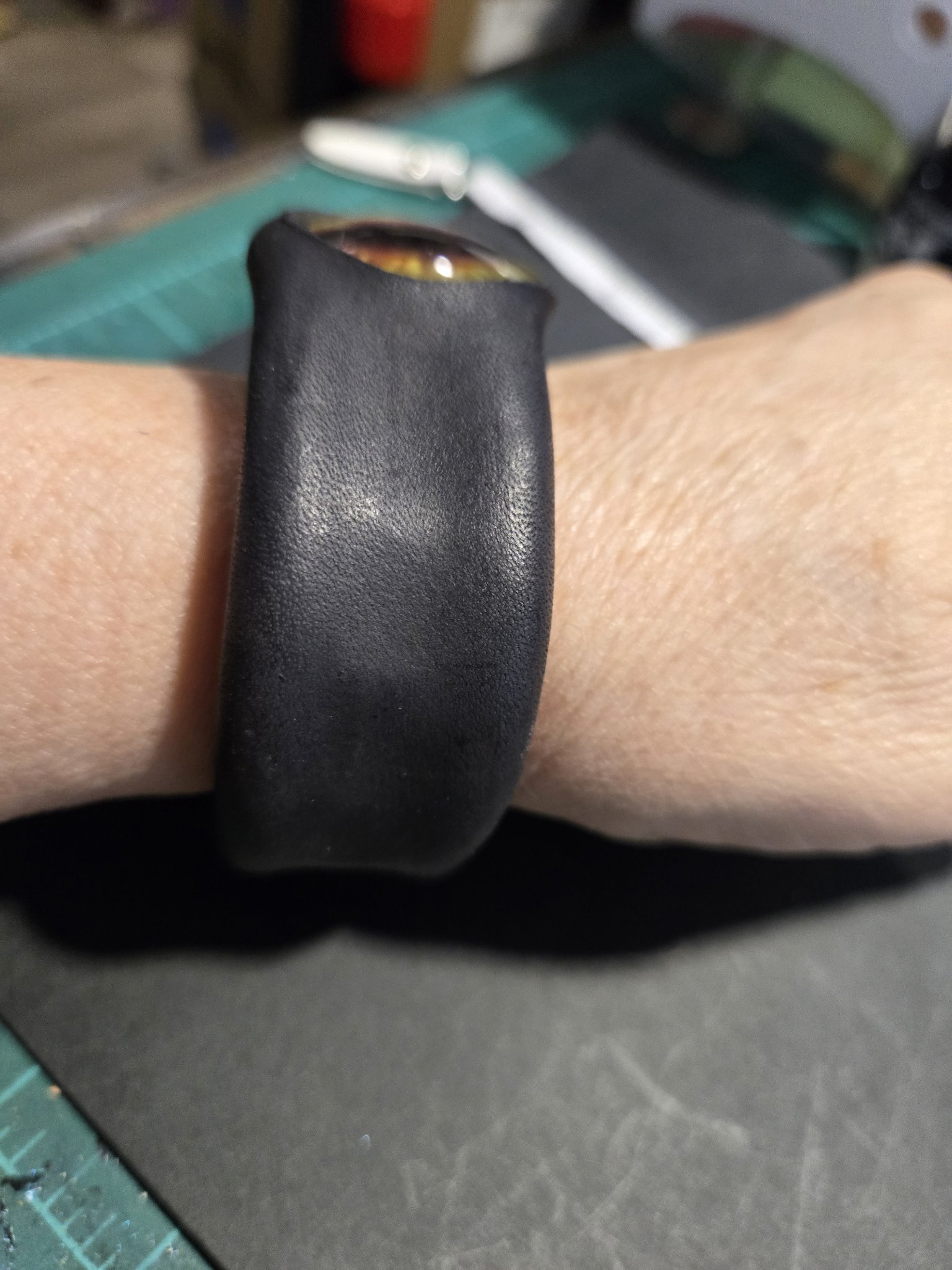 Side view of stock 227 on a wrist showing the beefy black leather band