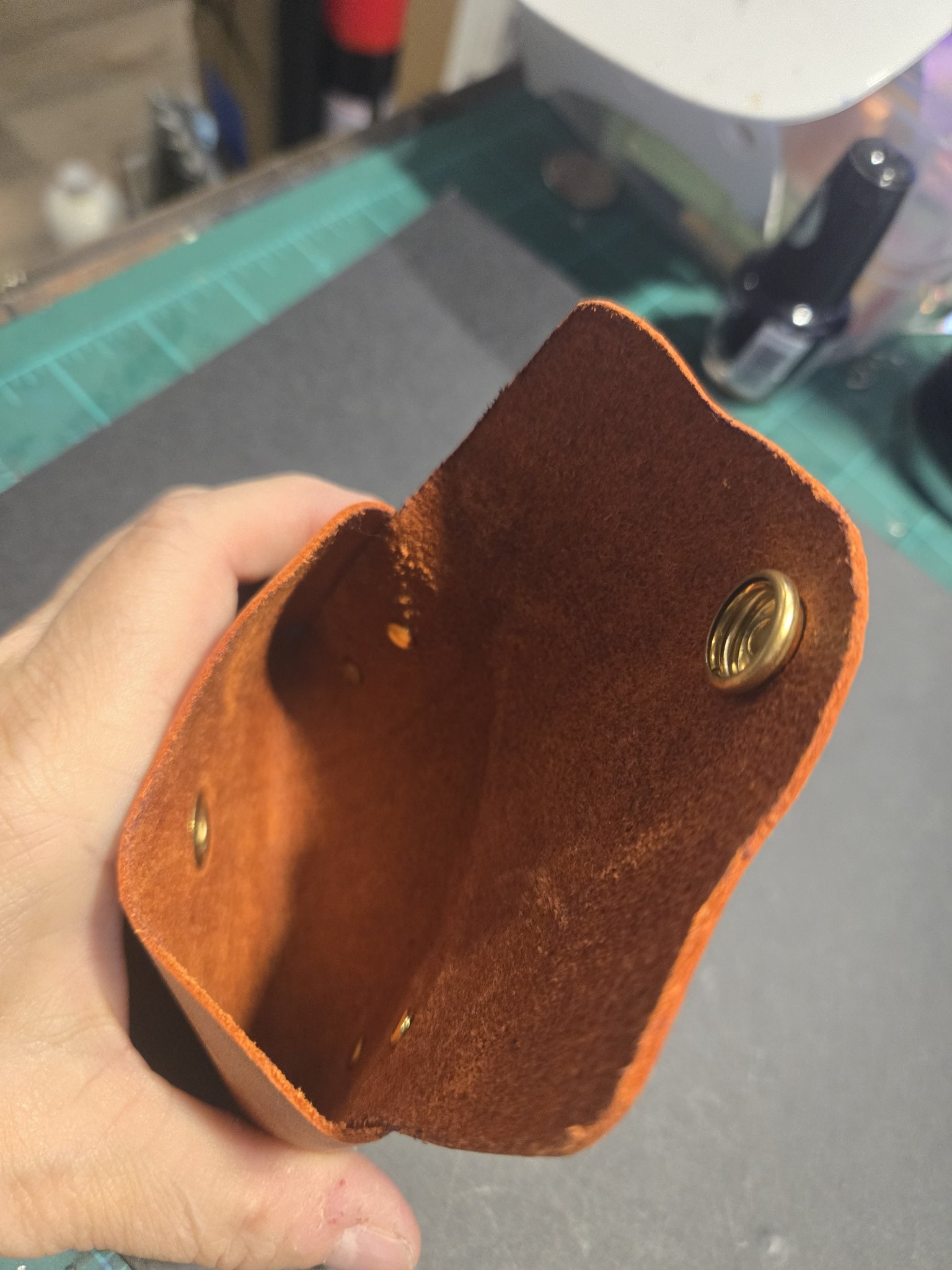 Stock 245 held open showing the soft suede interior and the brass snap